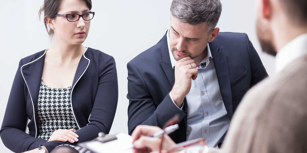 divorce-Wisconsin A couple sitting across from an attorney discussing divorce